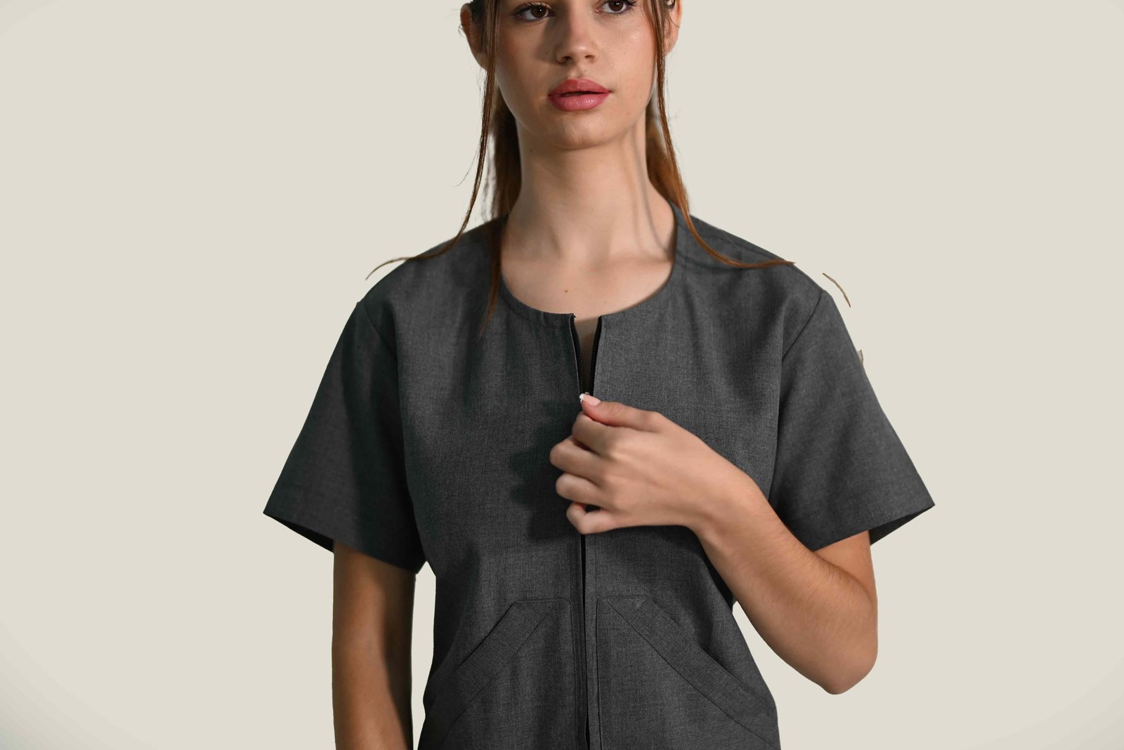 Detail view of V-neck short-sleeve healthcare uniform top, professional medical workwear.